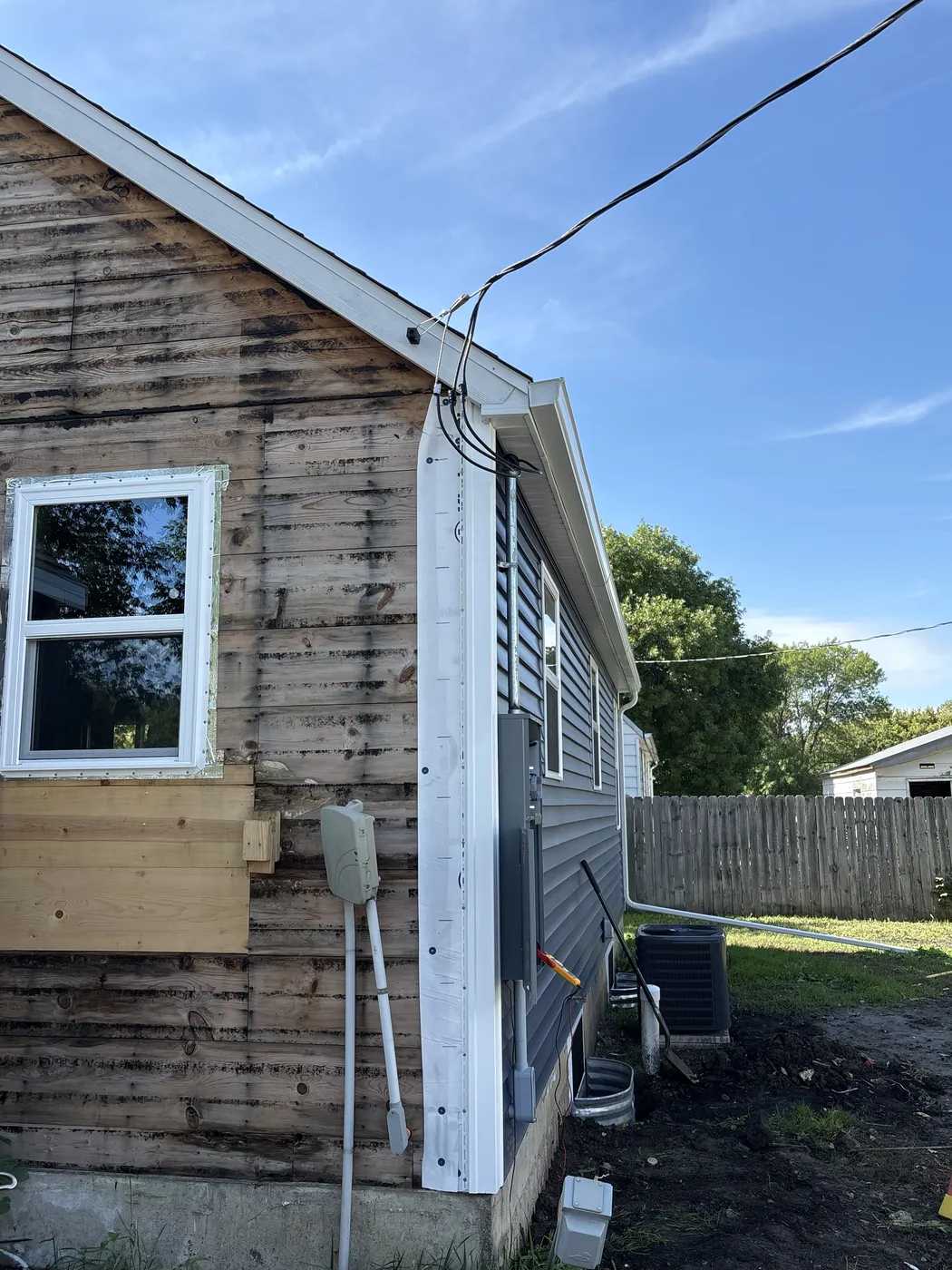 Old electrical service equipment on a Grygla, Minnesota home partway through a siding and window renovation